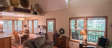 Living Room - Living room and kitchen and dining room. Living room has a wood fireplace.