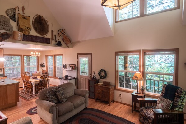 Living Room - Living room and kitchen and dining room. Living room has a wood fireplace.