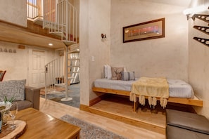 Living Room with cContemporary leather furnishings, a wood-burning fireplace, Smart TV with cable, and built-in, cozy reading nook