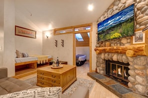 Living Room with cContemporary leather furnishings, a wood-burning fireplace, Smart TV with cable, and built-in, cozy reading nook