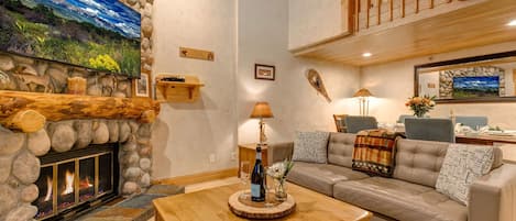 Living Room with Contemporary leather furnishings, a wood-burning fireplace, Smart TV with cable, and built-in, cozy reading nook