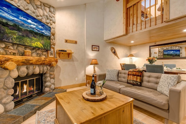 Living Room with Contemporary leather furnishings, a wood-burning fireplace, Smart TV with cable, and built-in, cozy reading nook