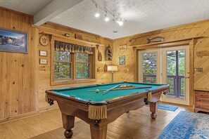 Game Room with Full-Size Pool Table, Comfortable Seating, and a TV