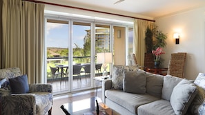 Bi-folding glass doors open up the entire living room for the tropical breeze.