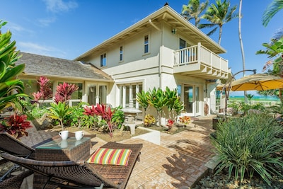Enjoy your morning coffee in the lush tropical backyard.