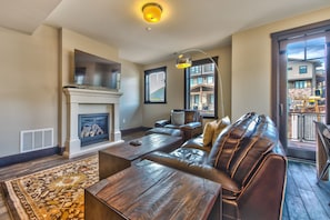 Living Room with a Gas Fireplace, 55 inch HD 4K Smart TV/Direct TV, Private Deck and a Full Bathroom with Heated Floors