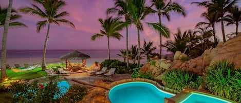 Gorgeous patio with pool and beach view during sunset