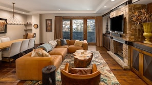 Enjoy the views from the cozy living area with fireplace and TV