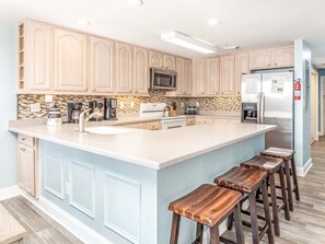 Fully Equipped Kitchen with large breakfast bar with seating