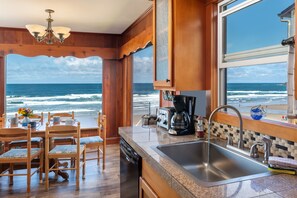 Kitchen and dining. - View from large oceanfront windows shows incredible sand, ocean and sky views.