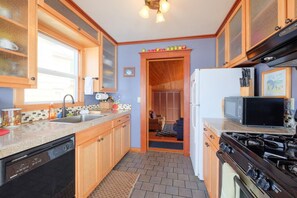 Well stocked kitchen - The kitchen opens to both living room and family room for ultimate entertaining.  Well stocked with anything you might need during your stay.