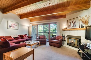 Living area with sectional and round chairs with feature fireplace