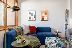 Melt into the plush couch and watch the skiers in the village