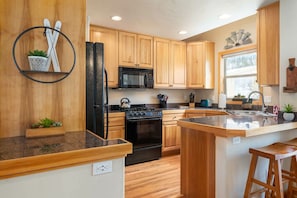 Kitchen on the main level with updated appliances (seating for three at the breakfast bar)