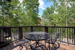 Cafe patio table on the front deck (grill for guest use not pictured)