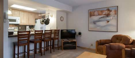 breakfast bar serves as dining area and seat fours