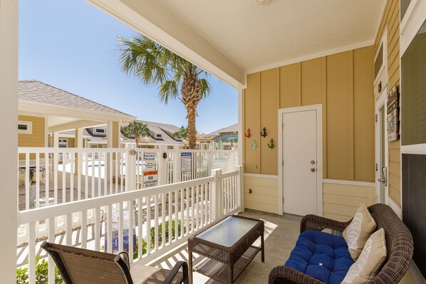Charming corner patio with a pool view