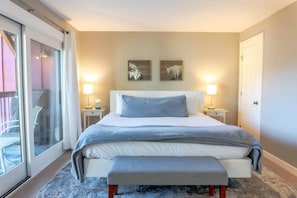 The guest bedroom is a beautiful space perfect for getting a restful night of sleep on the king size bed with gorgeous views out the sliding glass patio doors.