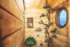 Our kelp forest showers with an ocean view in the Pioneer Cabin!