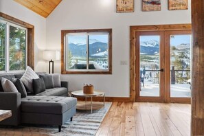 The remodeled home is filled with stylish decor and furnishings, with large windows throughout the home offering mountain views from all around.