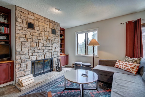 Trappeur 3 - a SkyRun Breckenridge Property - Living room with wood burning fireplace + flat screen TV