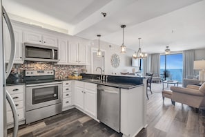 Fully Equipped Kitchen Features Stainless Steel Appliance, Custom Cabinets and Granite Counter Tops and a View