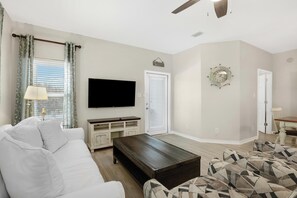 Living Area - The spacious living area features a new sofa sleeper, 2 comfortable chairs, and a mounted television. This is a perfect space for relaxing and spending quality time together.