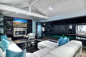 Modern and spacious living room with 80 inch HD TV