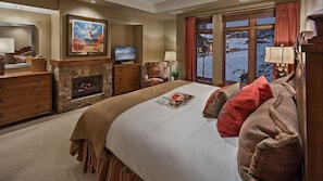 Primary suite with fireplace and TV