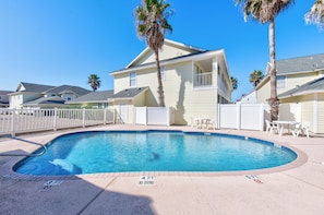 Sparkling pool with table and chairs to relax under the sun on your vacation