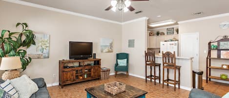 Lots of natural light in this comfy living area with flat screen TV