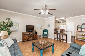 Lots of natural light in this comfy living area with flat screen TV