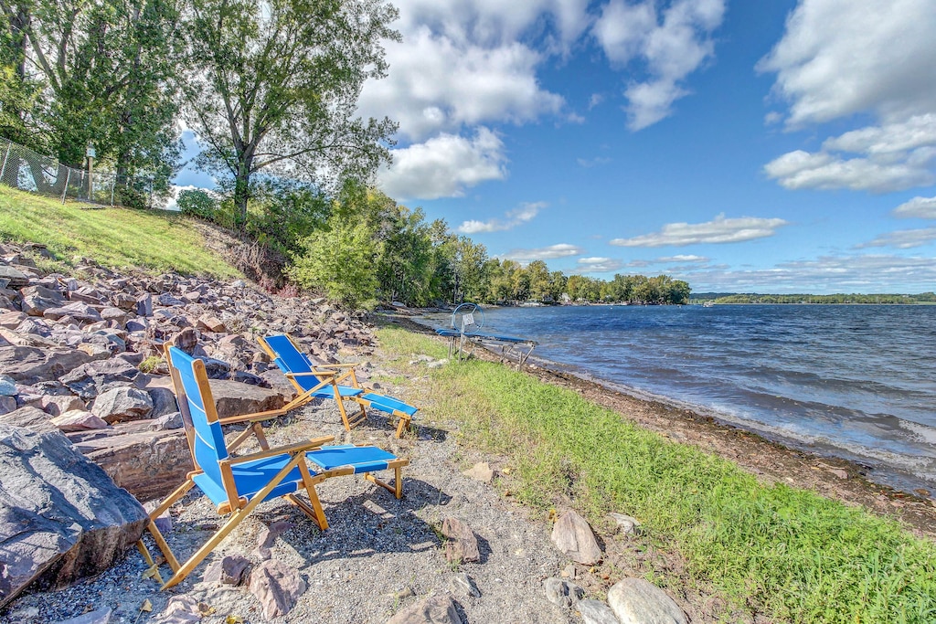 Two lounge chairs on a private Lake Champlain beach at a Vermont vacation rental on a sunny summer's day