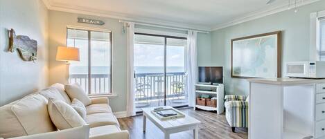 Living area with sleeper sofa, TV and access to balcony