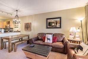 Living area with flat screen TV, gas fireplace and access to the private balcony.