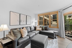 Living area with flat screen TV, gas fireplace and access to the private balcony.