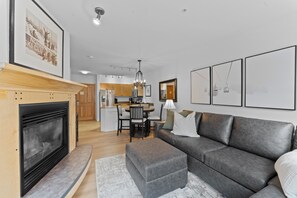 Living area with flat screen TV, gas fireplace and access to the private balcony.