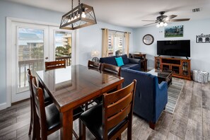Dining table with seating for six and balcony doors