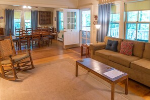 Unwind in the inviting living room, complete with a cozy fireplace and ample seating for family gatherings.