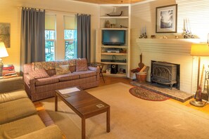 Unwind in the inviting living room, complete with a cozy fireplace and ample seating for family gatherings.