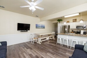 The kitchen, dining, and living areas blend seamlessly for a bright and airy feel