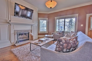Cozy main level living room with fireplace and flat screen TV