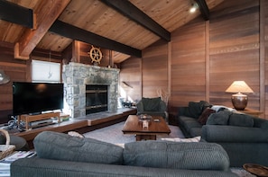 great room with beamed ceiling and big wood burning fireplace