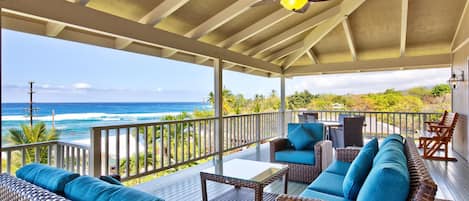 Lanai of this Kona Hawai'i vacation rental with cushioned seating and great views.