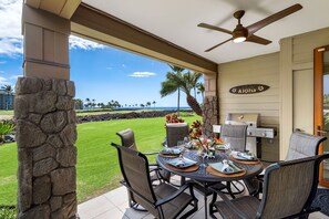 Lanai of this rental with grill and outside seating.