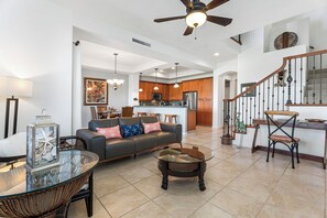 Living Area: Comfortable and inviting with a 50-inch flat-screen TV, wireless DVD player, and cozy seating