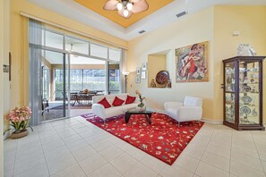GR12597 - Living with sliding doors opening up to the screened in lanai and pool area