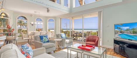 Relax in the living room area with a beach view