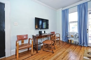 Roku TV with wooden table and chairs