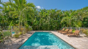 Outdoor Patio / Private Heated Pool with bank of chaise lounges